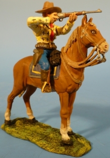Cowboy mit Gewehr schie�end zu Pferd