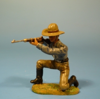 Cowboy mit Gewehr kniend schieend