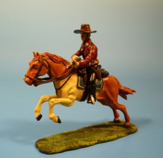 Cowboy zu Pferd Gewehr mit beiden H�nden haltend