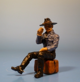 Cowboy sitzend rauchend