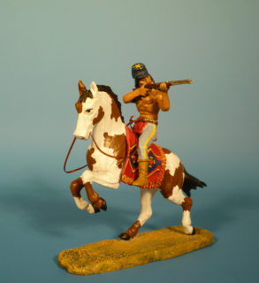 Apache zu Pferd mit Gewehr schieend